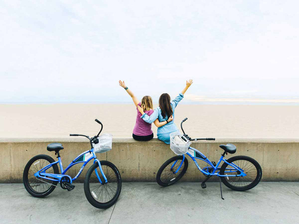 Friends With Bikes On The Beach.