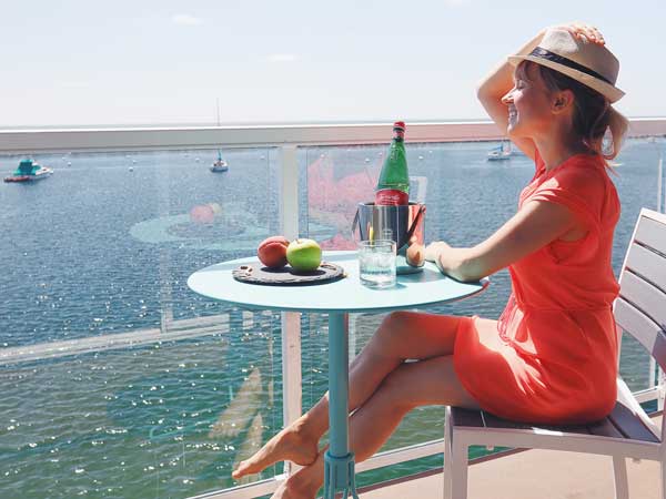 Woman Having A Snack On A Balcony.