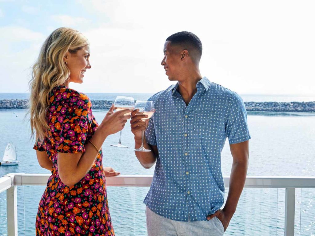 Couple Toasting On The Balcony.