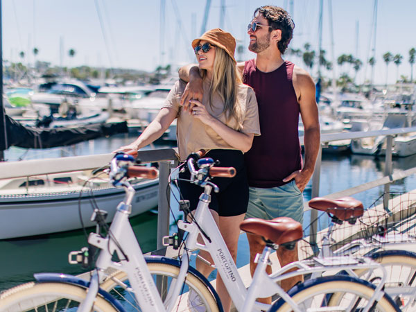 Couple Riding Bikes On The Marina.