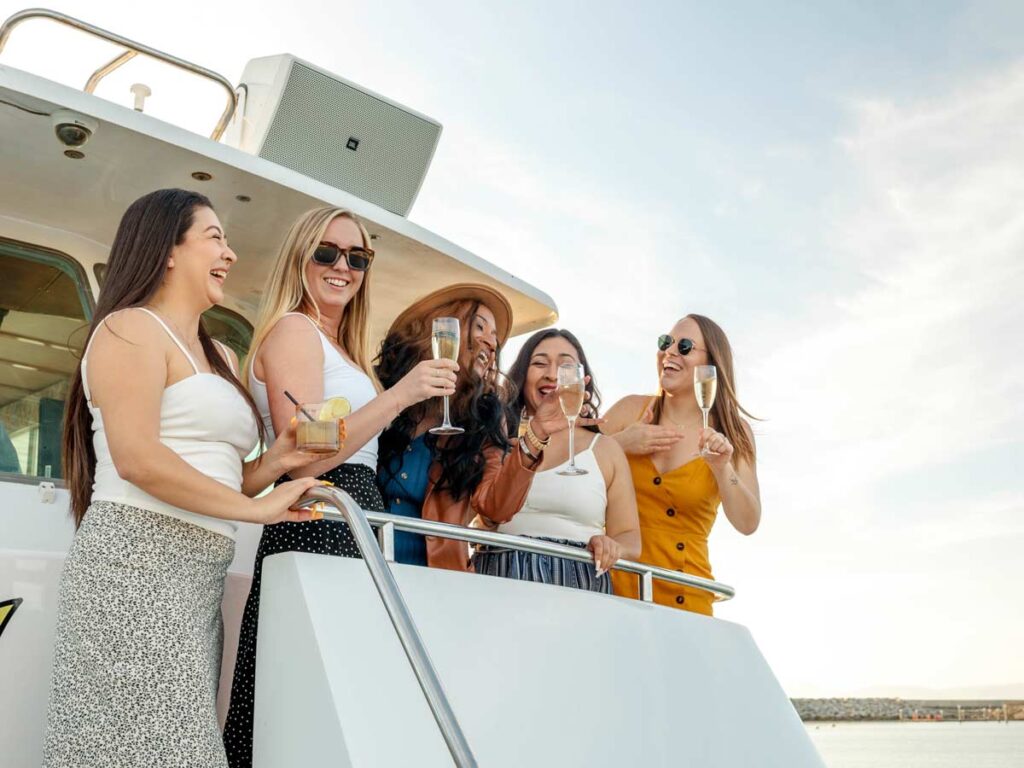Girls With Champagne On A Catamaran.