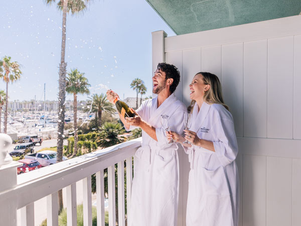 Couple Having Champagne On The Balcony.