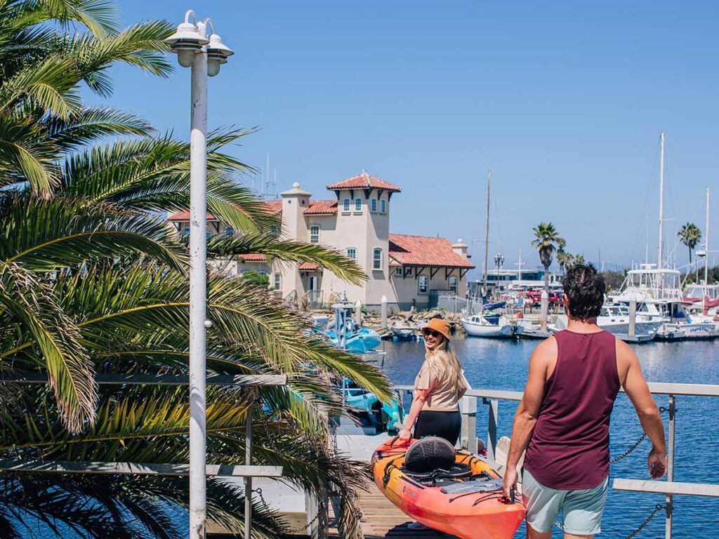 Couple Taking A Kayak Out In The Ocean