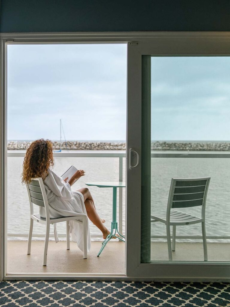 Lady On The Porch By The Ocean