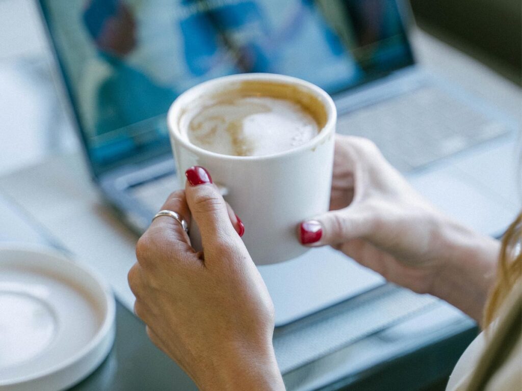 woman drinking coffee with laptop