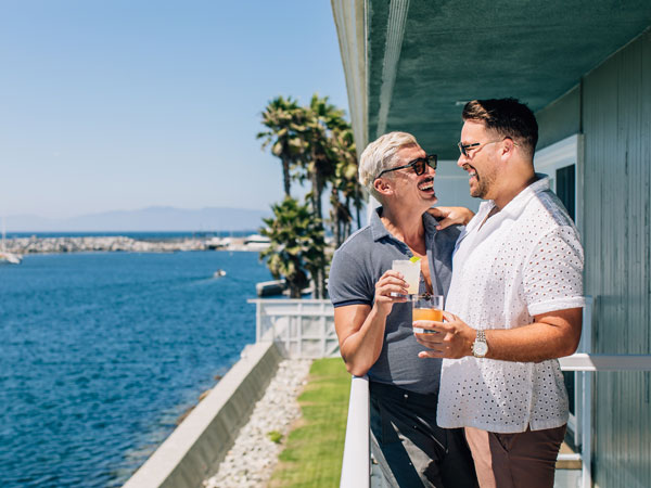 Guys With Drinks On Their Balcony