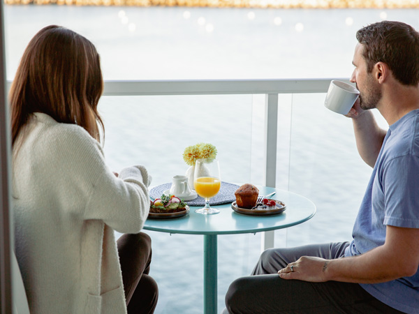 Couple Eating Breakfast On The Balcony