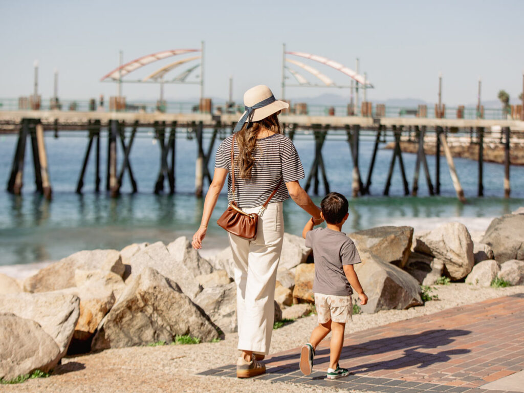 Mom And Son Walking By The Ocean