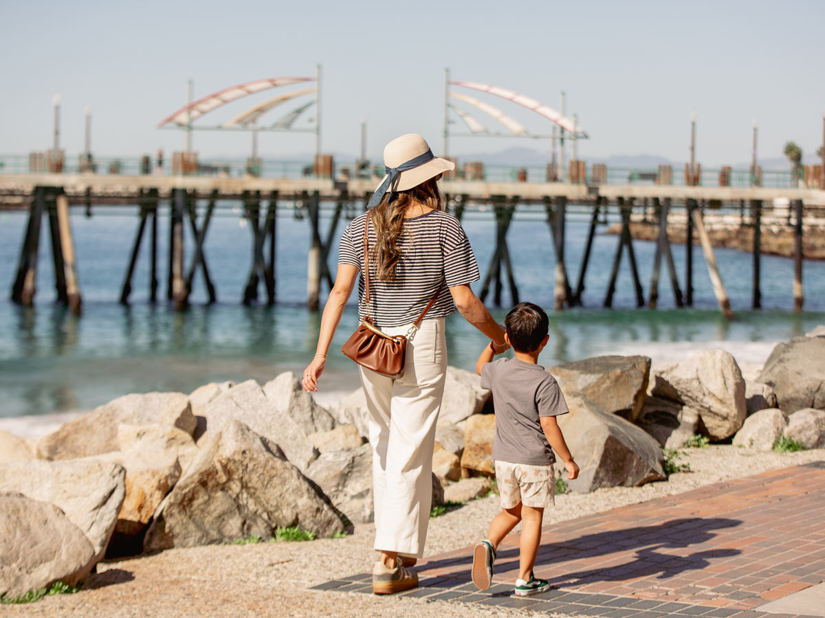 Mom And Son Walking By The Ocean