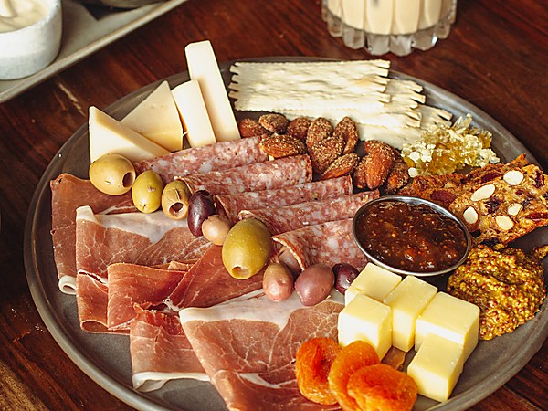 Charcuterie board with prosciutto, salami, cheeses, olives and truffle fries at A Coastal Christmas Bar, The Portofino Hotel & Marina in Redondo Beach